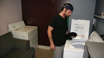 College girl Dakota Charms gives handjob in the laundry